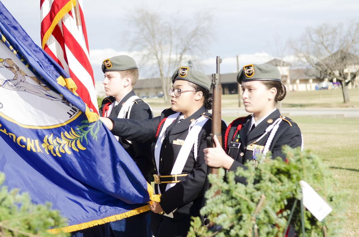 Honoring fallen – Volunteers hang 101 wreaths on post